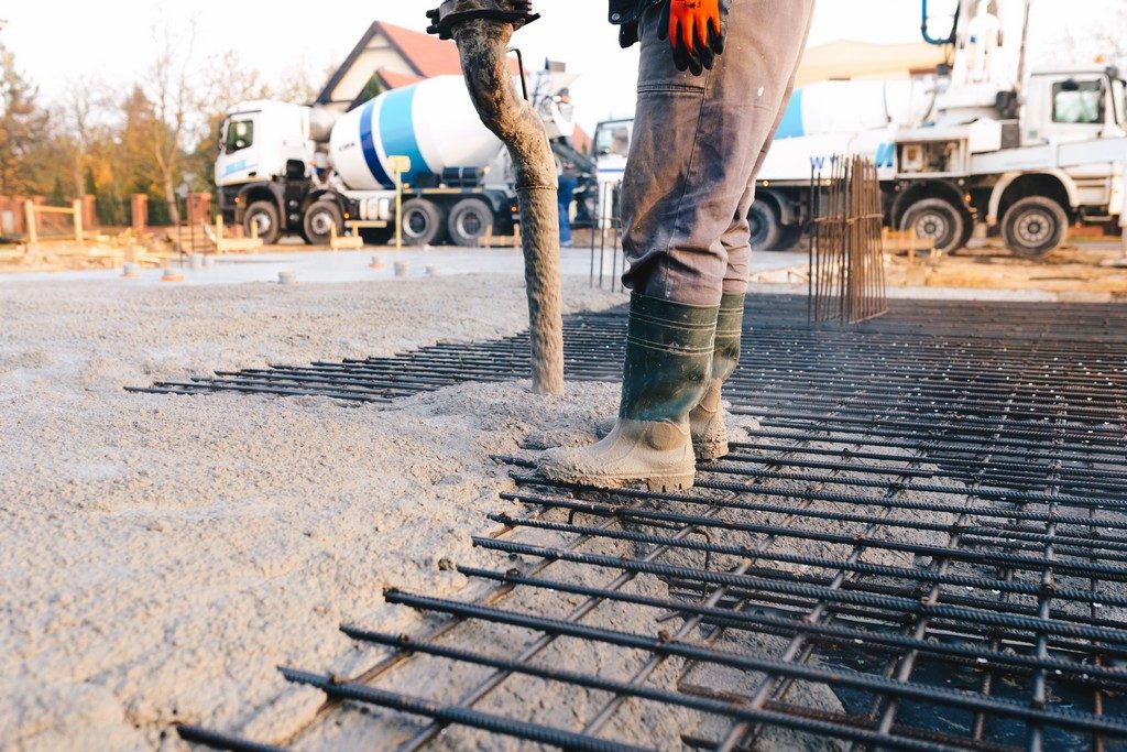 Concrete worker laying a foundation for a business in Coral Gables